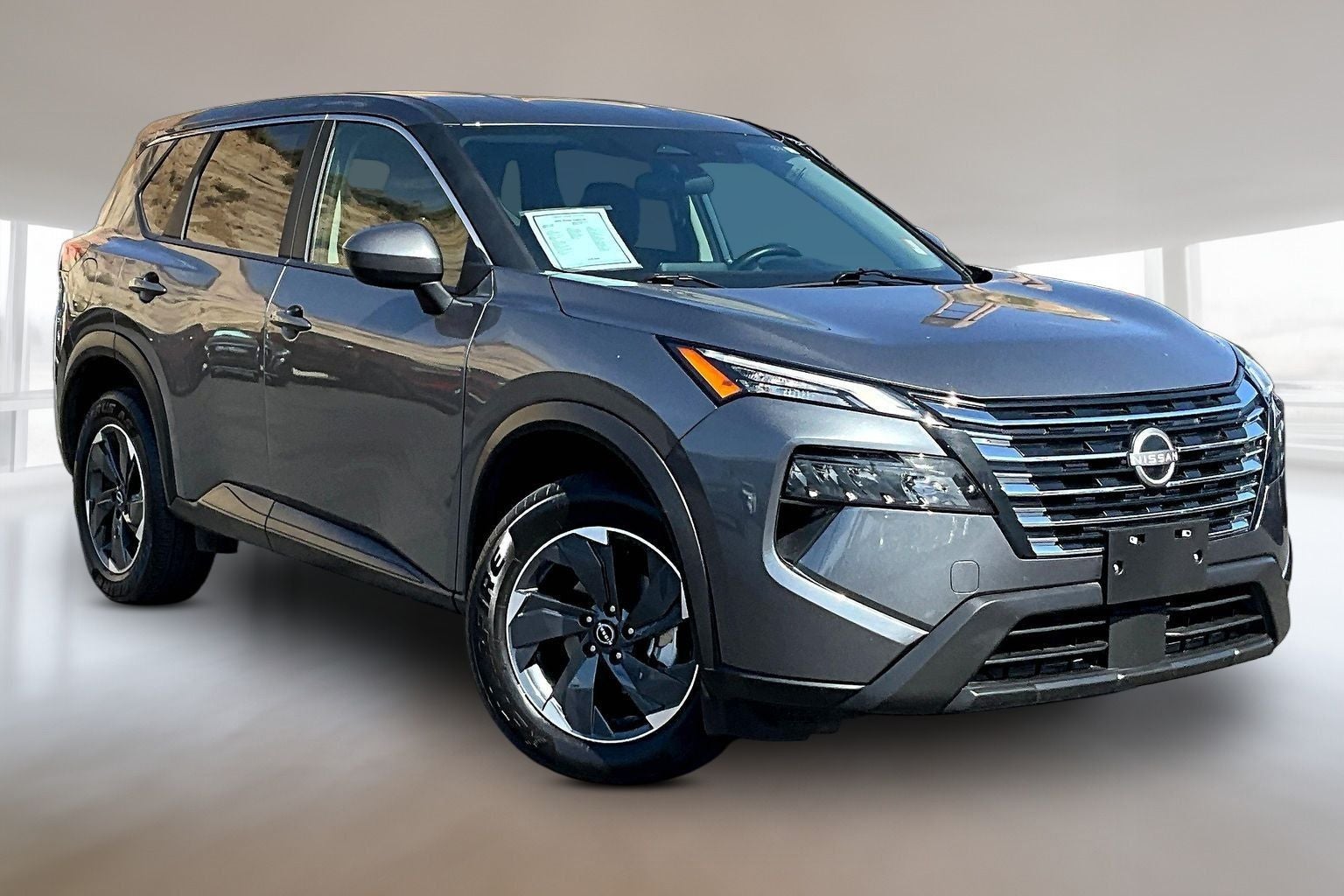 2025 Nissan Rogue SV in Gun Metallic — front three-quarter view